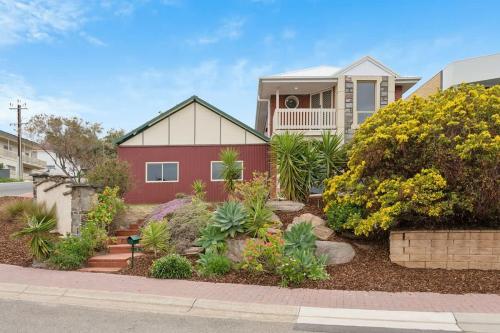 a house with plants in front of it at Sunset Ocean View Retreat 4BM House in Christies Beach