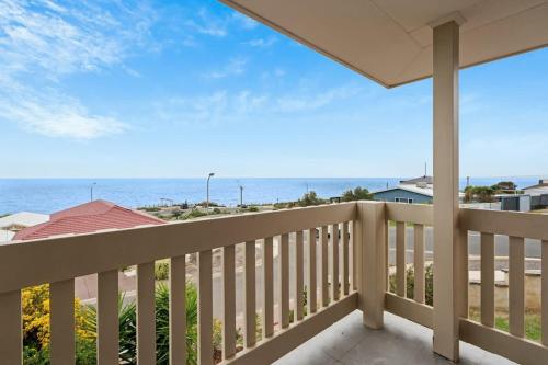 a balcony with a view of the ocean at Sunset Ocean View Retreat 4BM House in Christies Beach