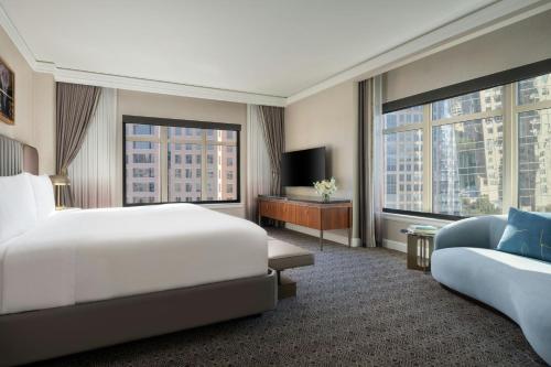 a hotel room with a bed and a couch at The Ritz-Carlton, Dallas in Dallas
