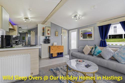 a living room with a couch and a table at Holiday Home in Hastings in Hastings