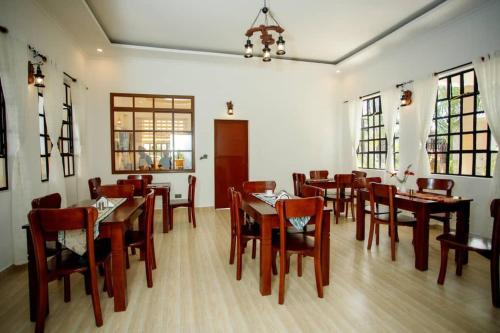 a dining room with tables and chairs in a restaurant at Pakihotels&apartment in Moshi