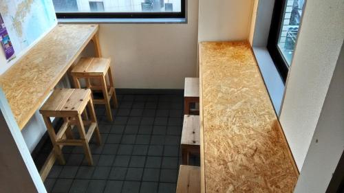 an overhead view of a room with tables and benches at Base Inn Komagome Tokyo in Tokyo