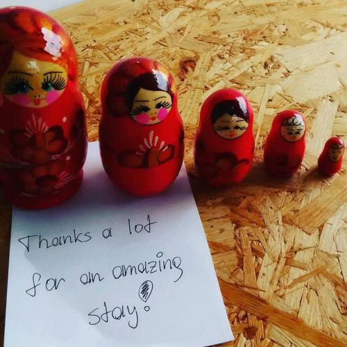 a group of dolls sitting next to a sign at Base Inn Komagome Tokyo in Tokyo