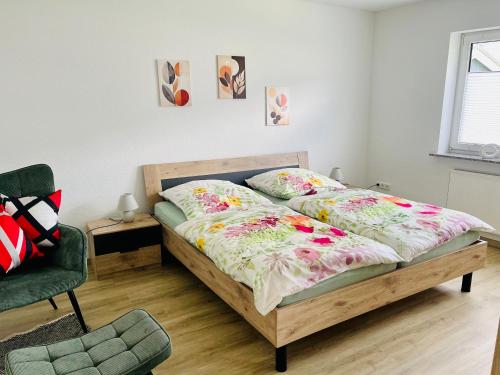 a bedroom with a bed and a chair at Mosel mit Herz in Cochem
