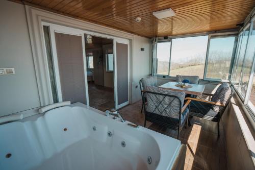 a bath tub in a room with a table and chairs at Montana Resort Otel in Trabzon