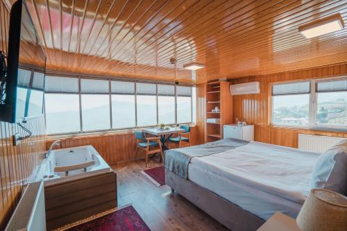 a bedroom in a boat with a bed and a desk at Montana Resort Otel in Trabzon