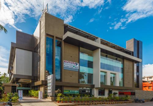 a building in a city with a blue sky at Samanvay Boutique Hotel in Udupi