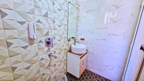 a bathroom with a sink and a shower at Haven On Hill - Rishikesh in Rishīkesh