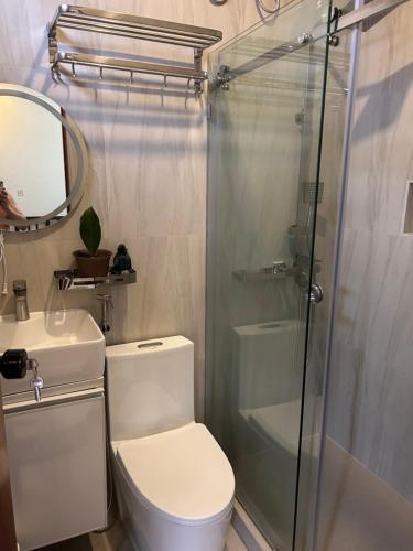 a bathroom with a toilet and a glass shower at Casa Villa Gracia in Bigaa