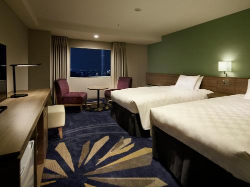 a hotel room with two beds and a window at Sunshine City Prince Hotel Ikebukuro Tokyo in Tokyo