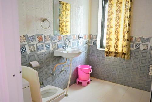 a bathroom with a sink and a toilet at Amar Bagh Ranthambore in Khilchipur
