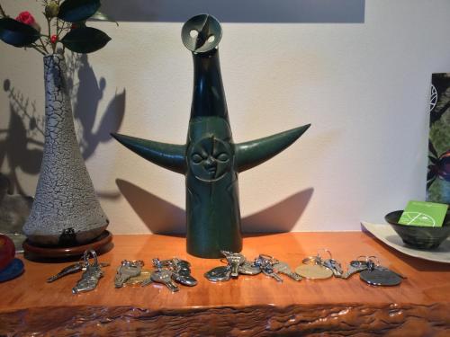 a green bottle sitting on top of a table with keys at Bamboo Village Guest House in Naoshima
