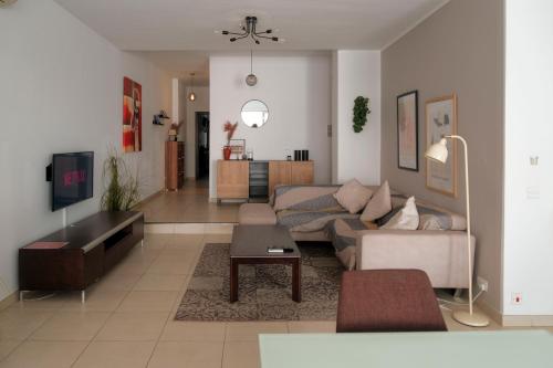 a living room with a couch and a table at The 501 by Shmoo in Sliema
