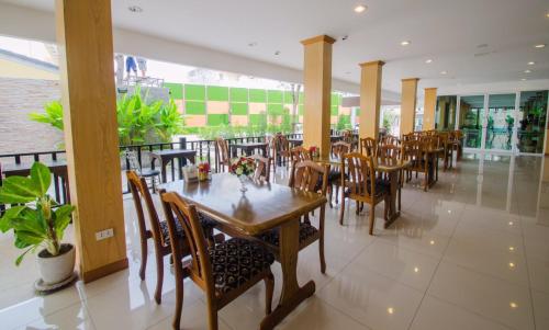 a dining room with tables and chairs in a restaurant at TH beach hotel in Hua Hin