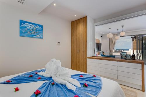 a bedroom with a bed with a towel on it at Angels Suites in Plataniás
