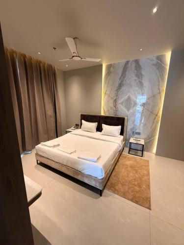 a bedroom with a large bed with white sheets at Hotel The Unify in Jāmb