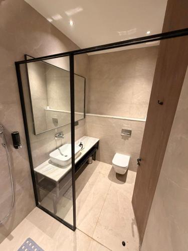 a bathroom with a sink and a toilet at Hotel The Unify in Jāmb