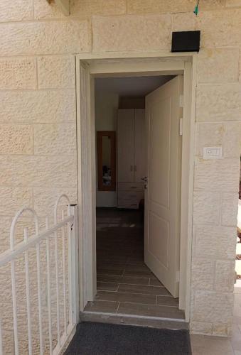 an entrance to a hallway with a white door at The Pearl in Sha‘alvim