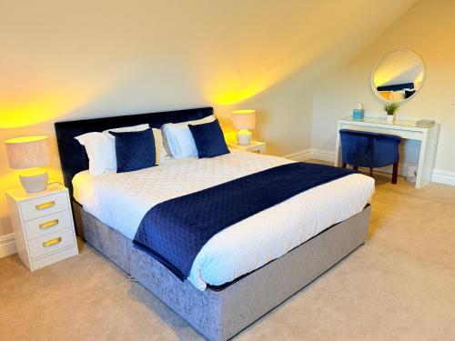 a bedroom with a large bed and a mirror at Country View House in Milltown