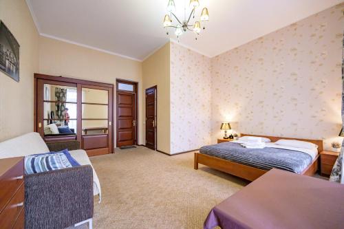 a bedroom with a bed and a table in a room at Hotel European 8 in Odesa