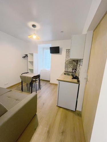 a kitchen and a living room with a table at Studio 2 Résidence Eugénie in Eaux-Bonnes