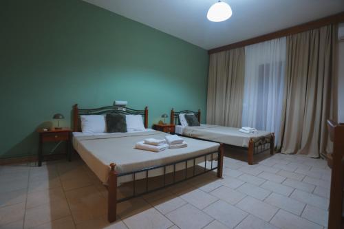 a bedroom with two beds with towels on them at Thermora Hotel in Orma