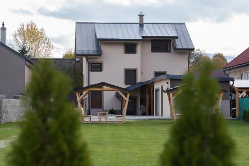 a house with solar panels on the roof at Apartmány Janka + camp in Bešeňová