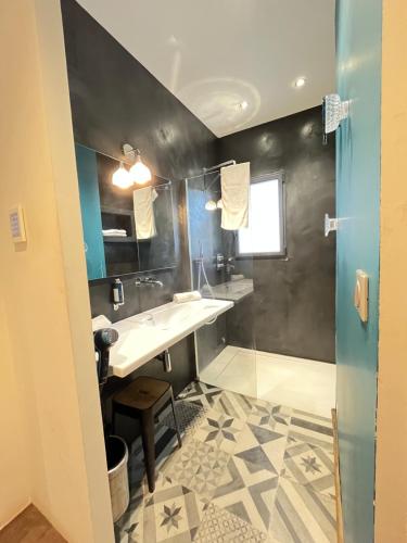 a bathroom with a sink and a shower at Maison d'Hôtes Bastia in Bastia