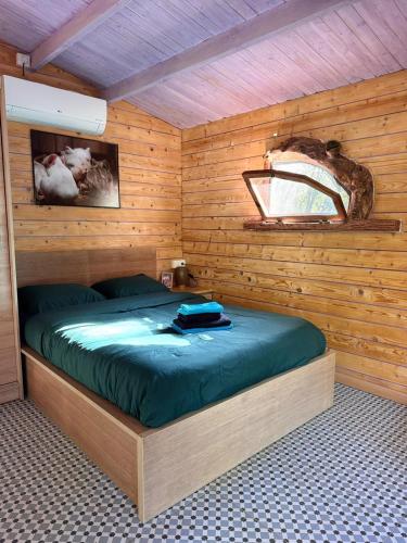 a bedroom with a bed in a wooden cabin at Can Cospito in Osor