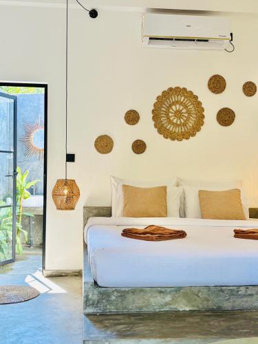 a bedroom with a white bed in a room at THE ISLaNDERS in Ahangama
