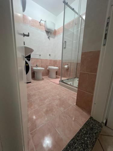 a bathroom with a shower and a toilet and a sink at perla house in Valledoria
