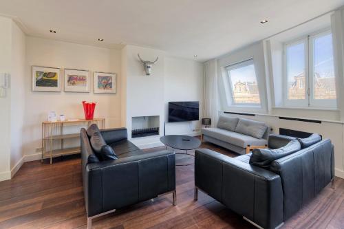 a living room with two couches and a tv at Marnix360apartments Jordaan in Amsterdam
