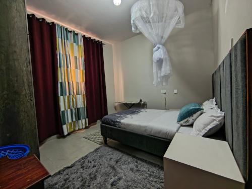 a small bedroom with a bed and a window at Vine Suites Mbarara Fully Furnished 1BR - Ideal for Short & Long Stays in Mbarara