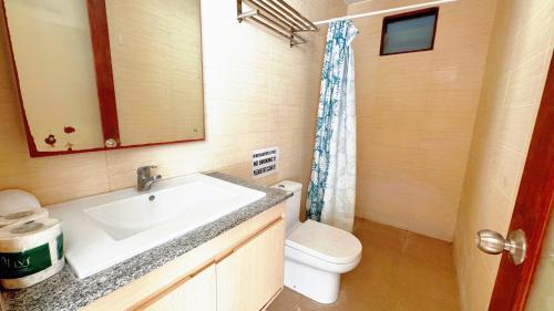 a bathroom with a sink and a toilet at Cozy Guest House Canggu in Kerobokan