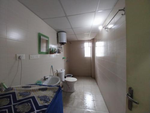 a bathroom with a toilet and a sink at Starlight Guest House in kolkata