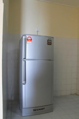 a stainless steel refrigerator in a room at Fullhouse Marina View Villas Apartment in Port Dickson