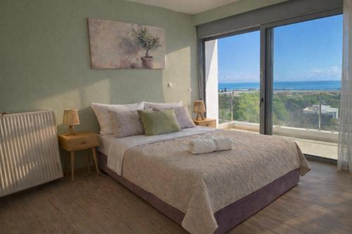 a bedroom with a bed with a view of the ocean at Alkion Villa Sea View, Olive Tree Garden & Spacious Terrace in Rhodes Town