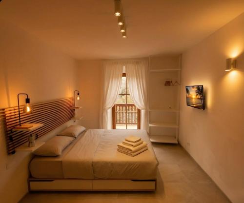 a bedroom with a large bed and a window at Centro Storico di Merano in Merano