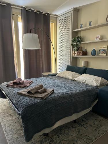 a bedroom with a bed with towels on it at Blue Roof in Fidenza