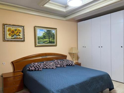 a bedroom with a blue bed with pillows on it at Villa Tenerife Sur in Adeje