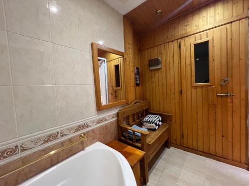 a bathroom with a tub and a mirror at Villa Tenerife Sur in Adeje