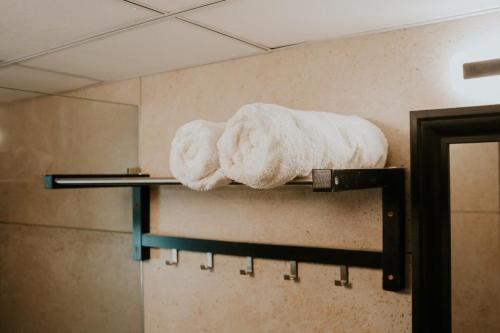 a shelf with two towels on it in a bathroom at Bella casa in Siolim