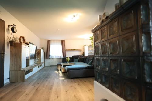 a living room with a couch and a table at Wasser & Bergwelt Appartement Kärnten in Seeboden