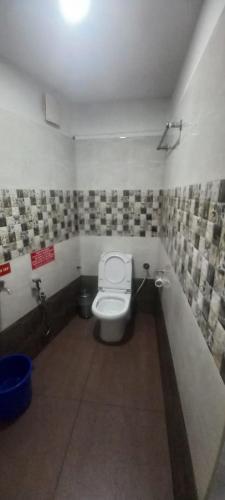 a bathroom with a toilet in a room at Hotel Bougainvillea in Cochin