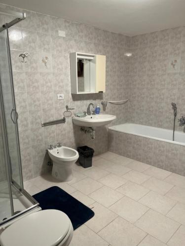 a bathroom with a toilet and a sink and a tub at Casa Maggini in Ancona