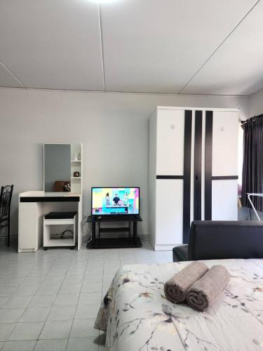 a living room with a bed and a television at Lovely Impact C3-C9 Lily in Nonthaburi