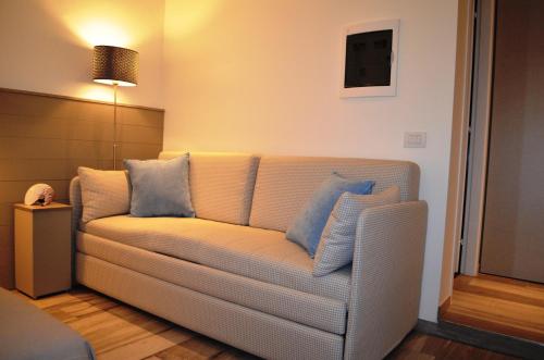 a living room with a couch with blue pillows at Appartamenti Barzilai in Gabicce Mare