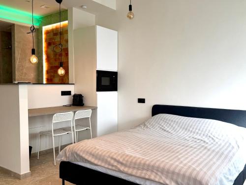 a bedroom with a bed and a kitchen with a counter at Salt Spa de Panne center in De Panne