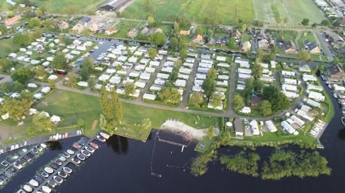 an aerial view of a parking lot next to the water at Camping Kleine Belterwijde, Trekkershut in Belt-Schutsloot