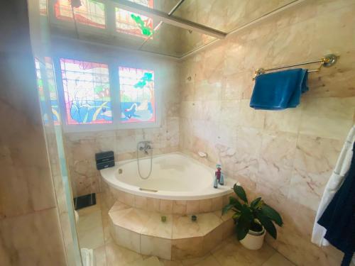 a bathroom with a tub and a window at Villa Eleni in Lagonissi